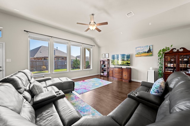 living room featuring baseboards, visible vents, a ceiling fan, wood finished floors, and vaulted ceiling