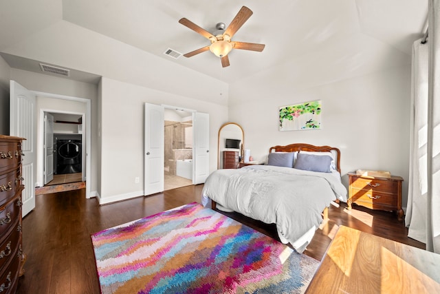 bedroom featuring washing machine and dryer, wood finished floors, visible vents, and baseboards