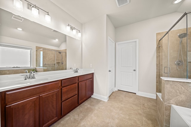 bathroom with a stall shower, visible vents, and a sink