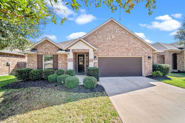 view of front of property with a garage, concrete driveway, brick siding, and a front yard