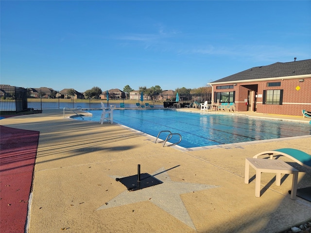 community pool featuring a patio area and fence