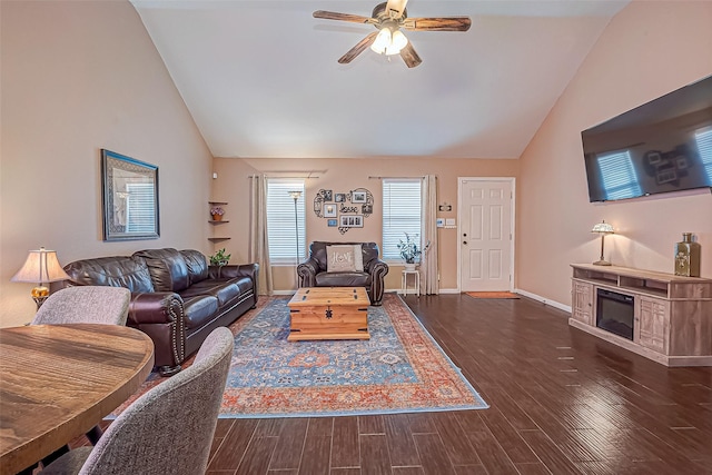 306 Marion St, Brazoria, TX 77422 - living room featuring a ceiling fan, dark wood-style flooring, baseboards, a glass covered fireplace, and high vaulted ceiling