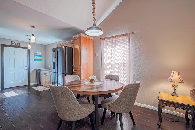 306 Marion St, Brazoria, TX 77422 - dining area with a textured wall, baseboards, and dark wood-style floors
