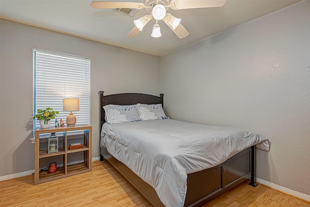 306 Marion St, Brazoria, TX 77422 - bedroom featuring wood finished floors, baseboards, and a ceiling fan