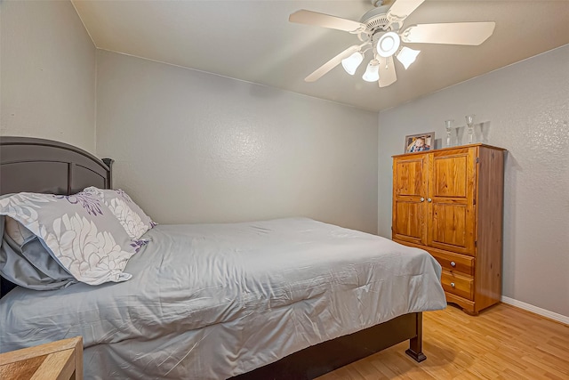 306 Marion St, Brazoria, TX 77422 - bedroom with light wood-style flooring, baseboards, and a ceiling fan