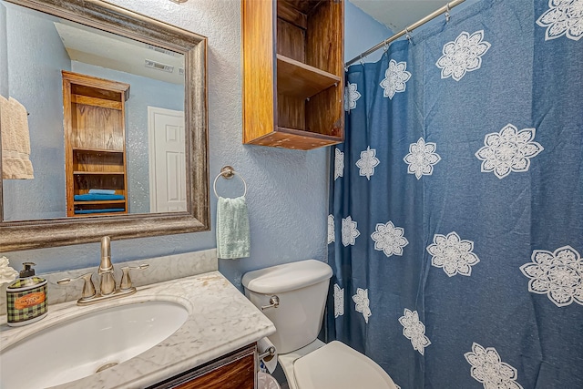 306 Marion St, Brazoria, TX 77422 - bathroom with a textured wall, vanity, toilet, and a shower with shower curtain