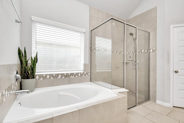 bathroom with lofted ceiling, a shower stall, and a bath