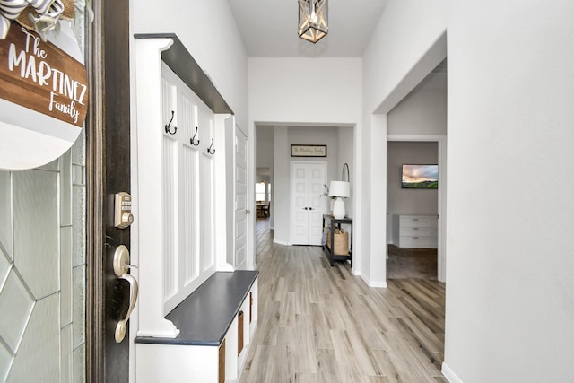 mudroom with light wood-style flooring and baseboards