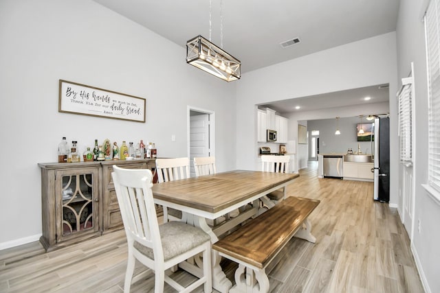 dining area featuring light wood-style floors, recessed lighting, visible vents, and baseboards