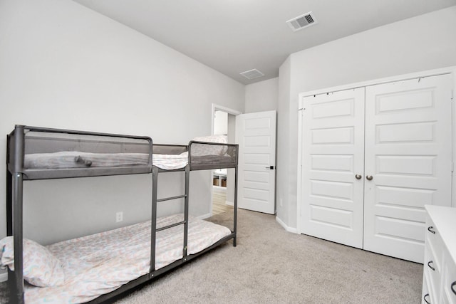 bedroom with carpet, a closet, visible vents, and baseboards