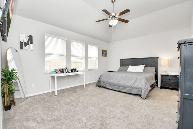 carpeted bedroom with lofted ceiling, ceiling fan, and baseboards