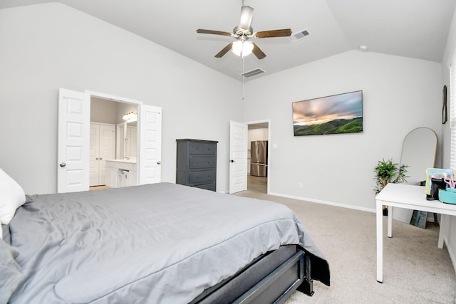 bedroom with carpet, lofted ceiling, visible vents, freestanding refrigerator, and baseboards