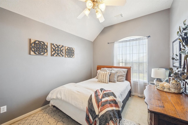 bedroom featuring a ceiling fan, lofted ceiling, and baseboards