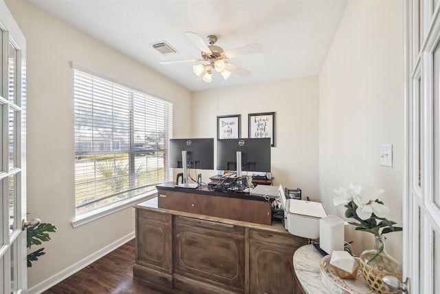 home office featuring a ceiling fan, dark wood finished floors, visible vents, and baseboards