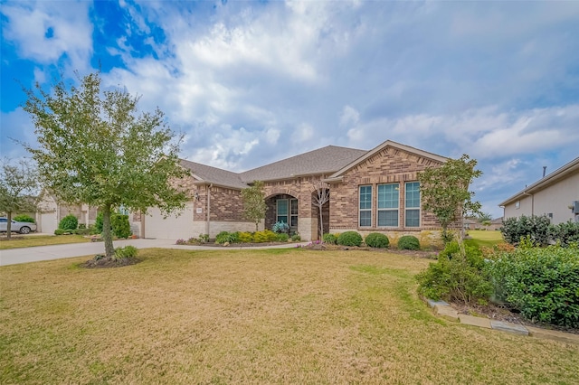 view of front facade featuring driveway, an attached garage, a front yard, and brick siding