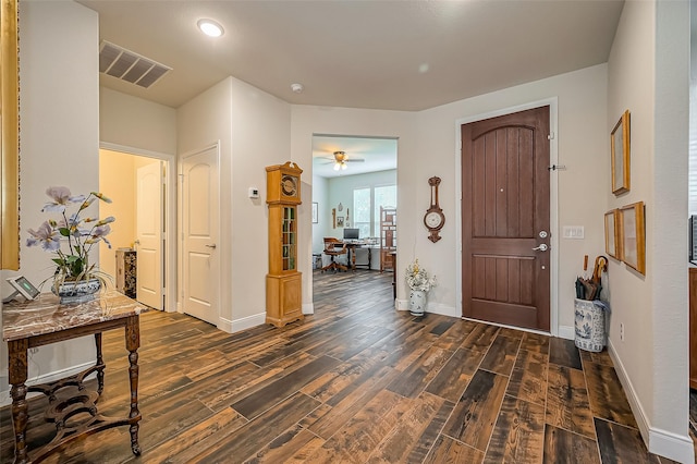 foyer featuring dark wood-style floors, visible vents, and baseboards