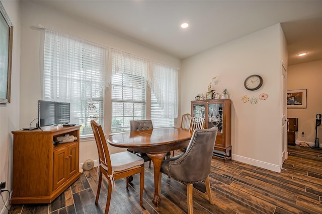 dining space with wood finish floors, baseboards, and recessed lighting