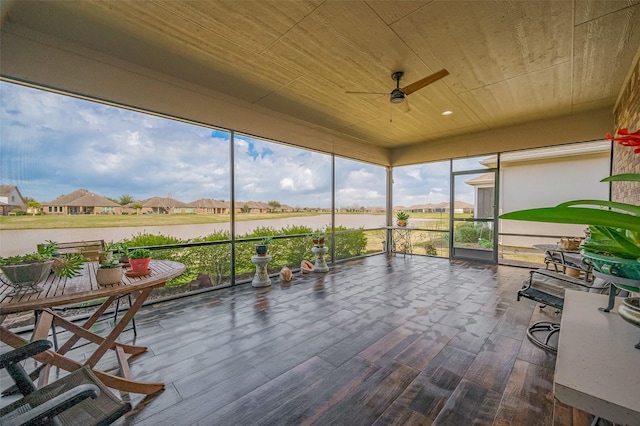 unfurnished sunroom featuring ceiling fan and wood ceiling