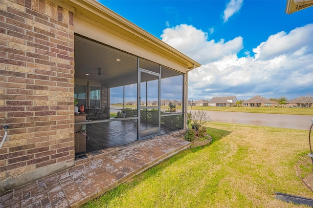 view of yard with a water view, a residential view, and a sunroom