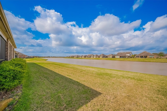 view of yard featuring a water view and a residential view