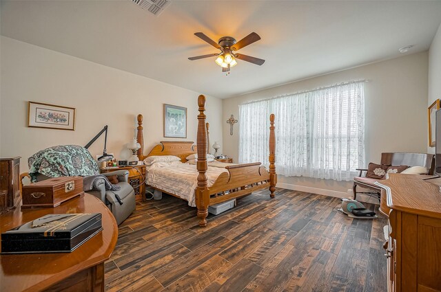 bedroom featuring baseboards, visible vents, dark wood finished floors, and a ceiling fan