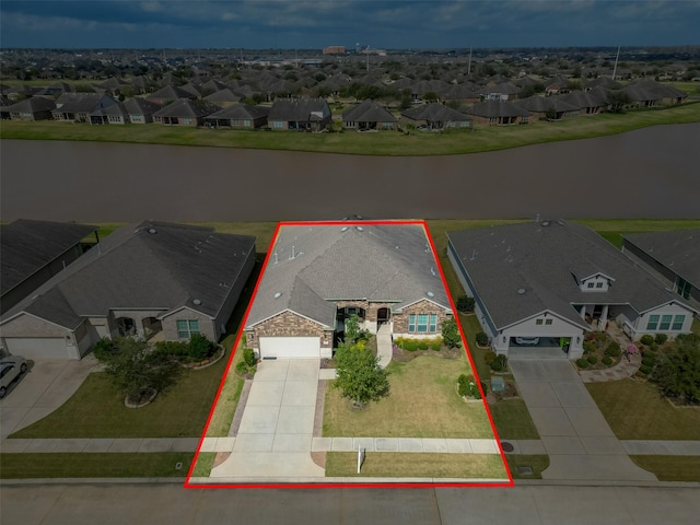 bird's eye view featuring a water view and a residential view