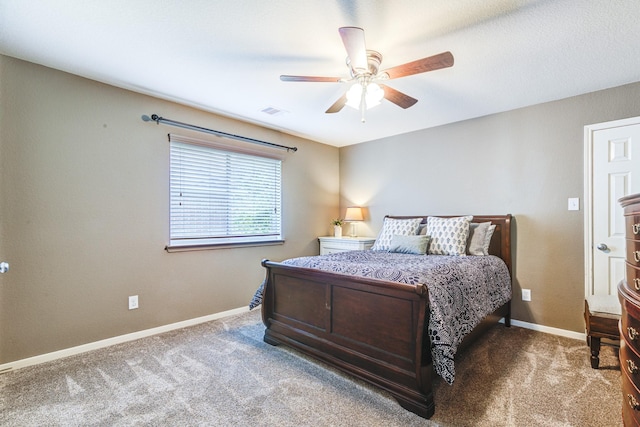 carpeted bedroom featuring a ceiling fan, visible vents, and baseboards