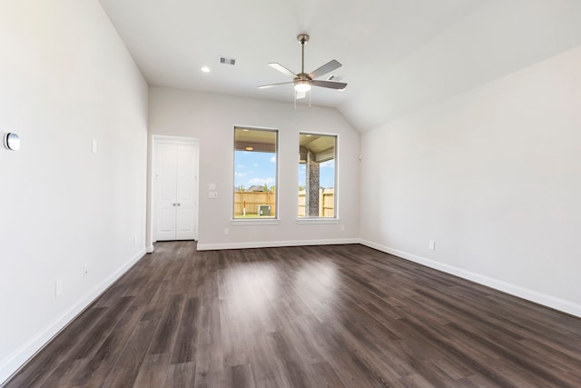 unfurnished room with visible vents, dark wood-type flooring, baseboards, ceiling fan, and vaulted ceiling