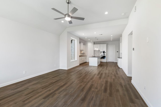 unfurnished living room with a ceiling fan, a sink, dark wood finished floors, recessed lighting, and baseboards