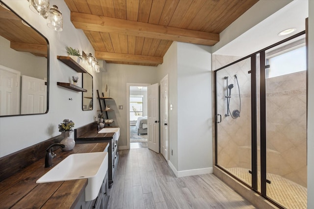 bathroom with wood ceiling, a shower stall, beam ceiling, and wood finished floors