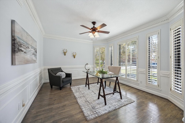 office space with a ceiling fan, dark wood-style floors, ornamental molding, a textured ceiling, and a decorative wall