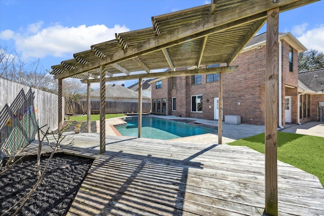 view of pool with a fenced in pool, a fenced backyard, a wooden deck, and a pergola