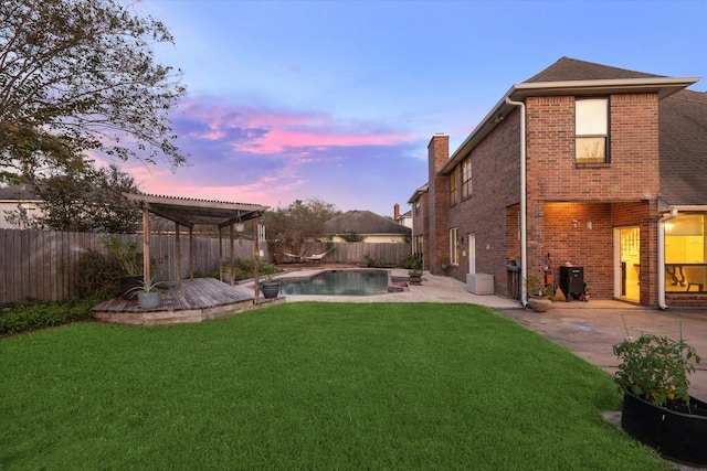 yard at dusk featuring a patio, a fenced backyard, a fenced in pool, and a pergola