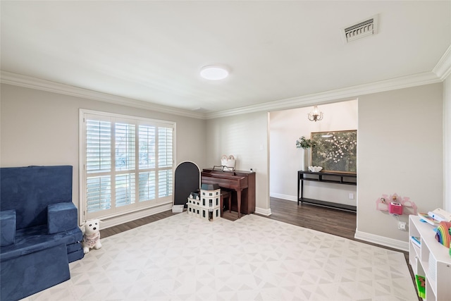 office space featuring baseboards, visible vents, wood finished floors, and ornamental molding