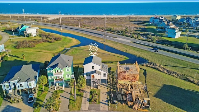 birds eye view of property featuring a water view and a residential view