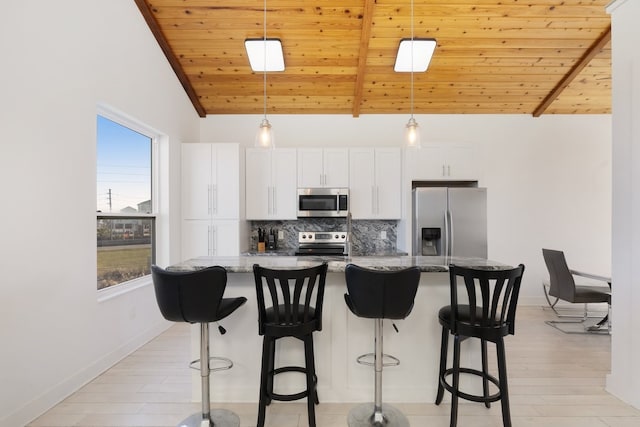 kitchen with appliances with stainless steel finishes, wooden ceiling, a kitchen island with sink, and decorative backsplash