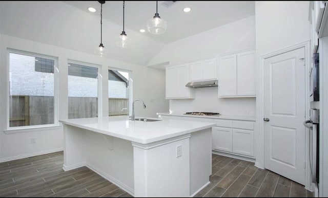 kitchen with gas stovetop, white cabinets, a sink, and wood finish floors