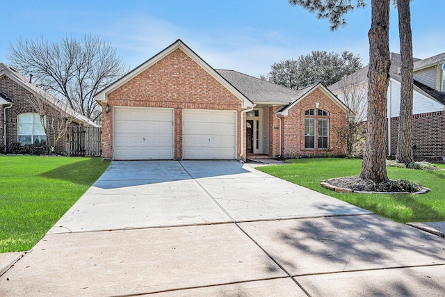 view of front of property featuring brick siding, roof with shingles, a garage, driveway, and a front lawn