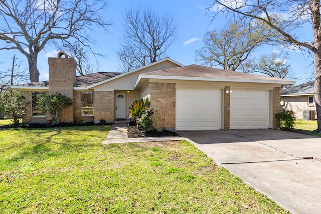 view of front of property with concrete driveway, a chimney, an attached garage, a front lawn, and brick siding