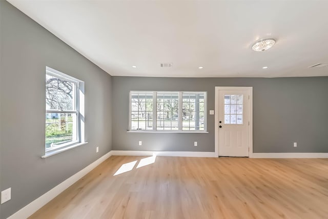 entrance foyer featuring light wood-type flooring, baseboards, and visible vents