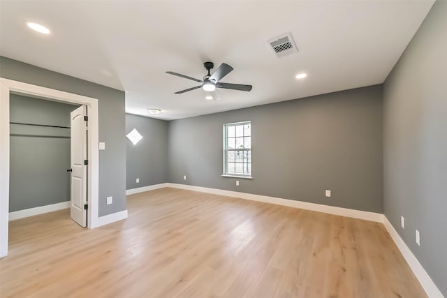 unfurnished bedroom featuring light wood-style flooring, visible vents, and baseboards