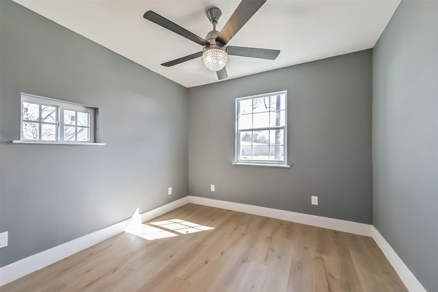 unfurnished room featuring a ceiling fan, baseboards, and wood finished floors