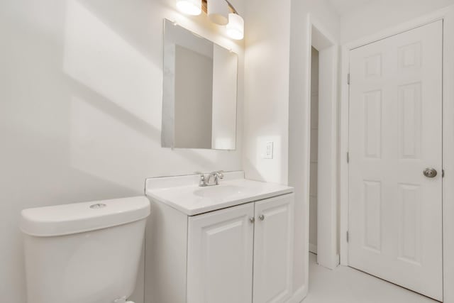 half bathroom featuring toilet and vanity