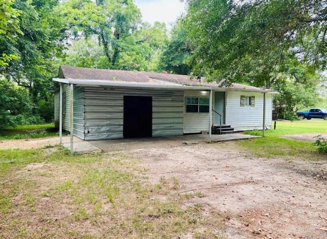 view of outbuilding with entry steps and driveway