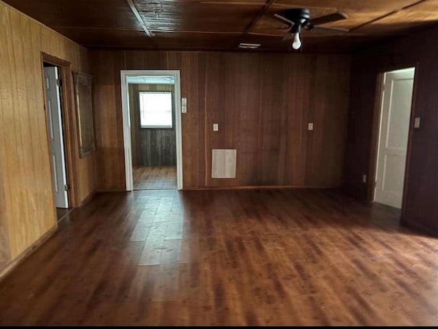 unfurnished room with wooden ceiling, wood walls, and dark wood-type flooring