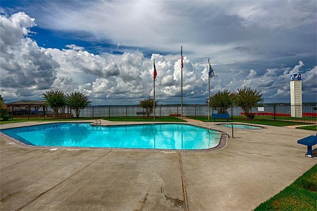 pool featuring fence and a patio