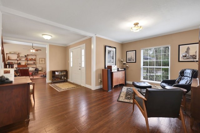 interior space featuring ornamental molding, dark wood-style flooring, ceiling fan, and baseboards