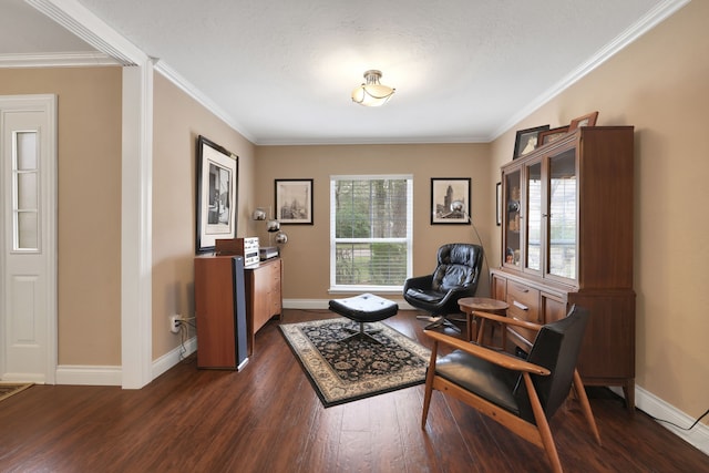 sitting room with dark wood-style flooring, crown molding, and baseboards