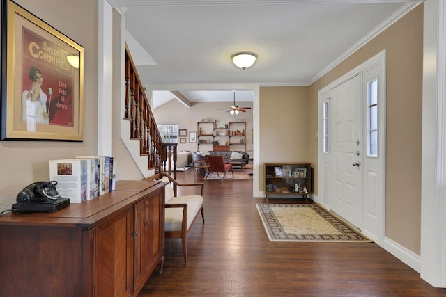 entryway featuring baseboards, ceiling fan, stairway, dark wood-type flooring, and crown molding