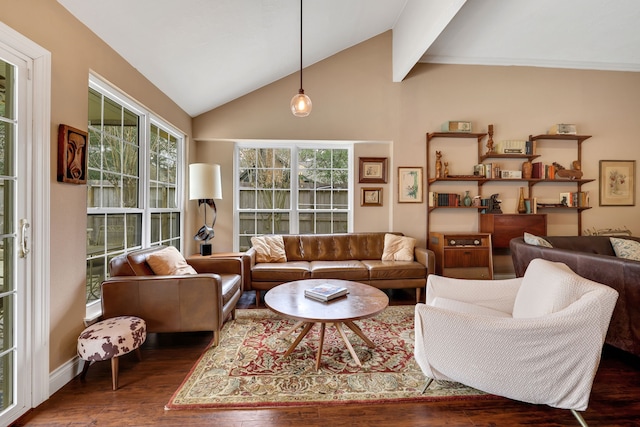 living area featuring lofted ceiling with beams, wood finished floors, and baseboards